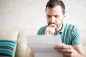 %Focuskw% | Grapids Home Services man looking at piece of paper with concerned look