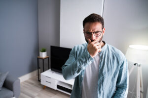 %Focuskw% | Grapids Home Services Man noticing a bad smell or odor from an HVAC in the house