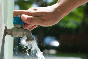 %Focuskw% | Grapids Home Services hand of woman she was using her hand to shut the flowing water from faucet